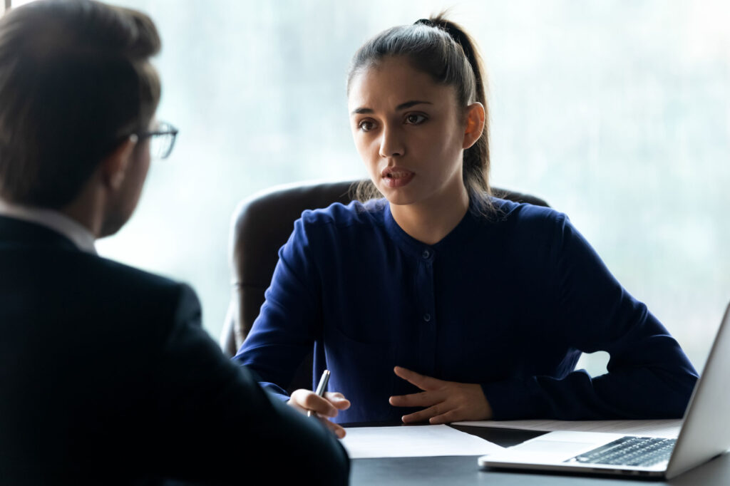 Sales professional leading a client through a pros and cons decision-making conversation.